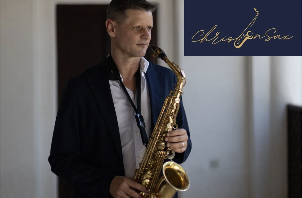 Chris, private saxophone teacher in Dubai, holding a gold alto saxophone